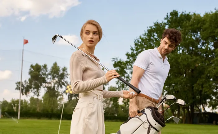 Two golfers chatting by their bags