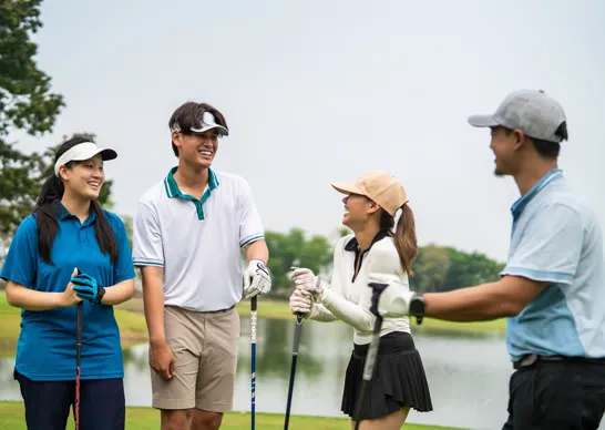 Colleagues laughing together on the course