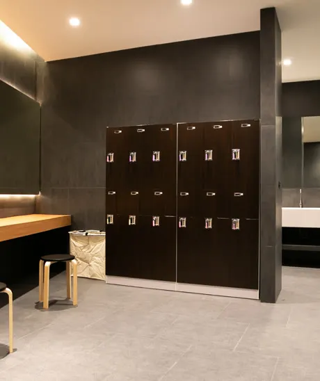 Dark wood lockers in a softly lit changing room