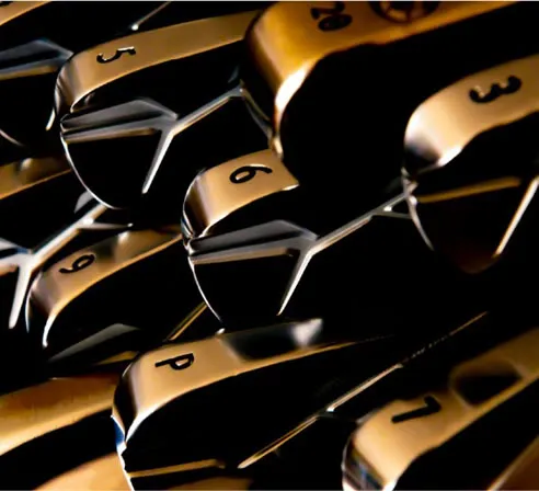 Close-up of gold-trimmed golf irons