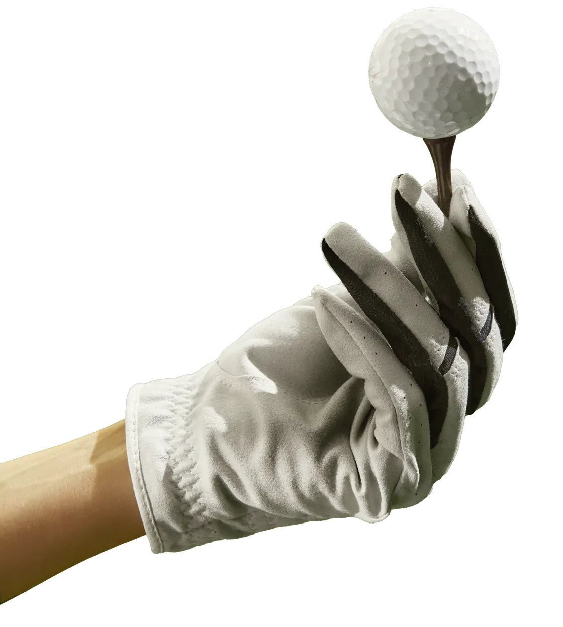 Gloved hand holding a golf ball on a tee