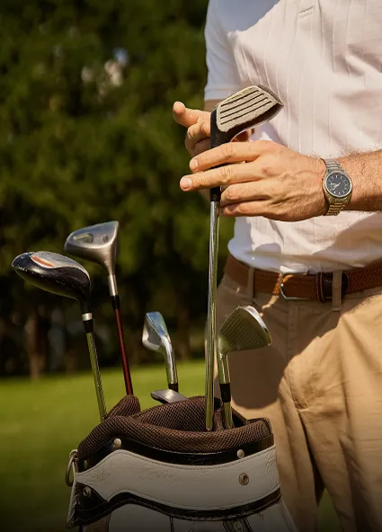 Golfer drawing an iron from his bag