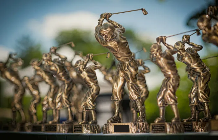 Row of bronze golfer trophies