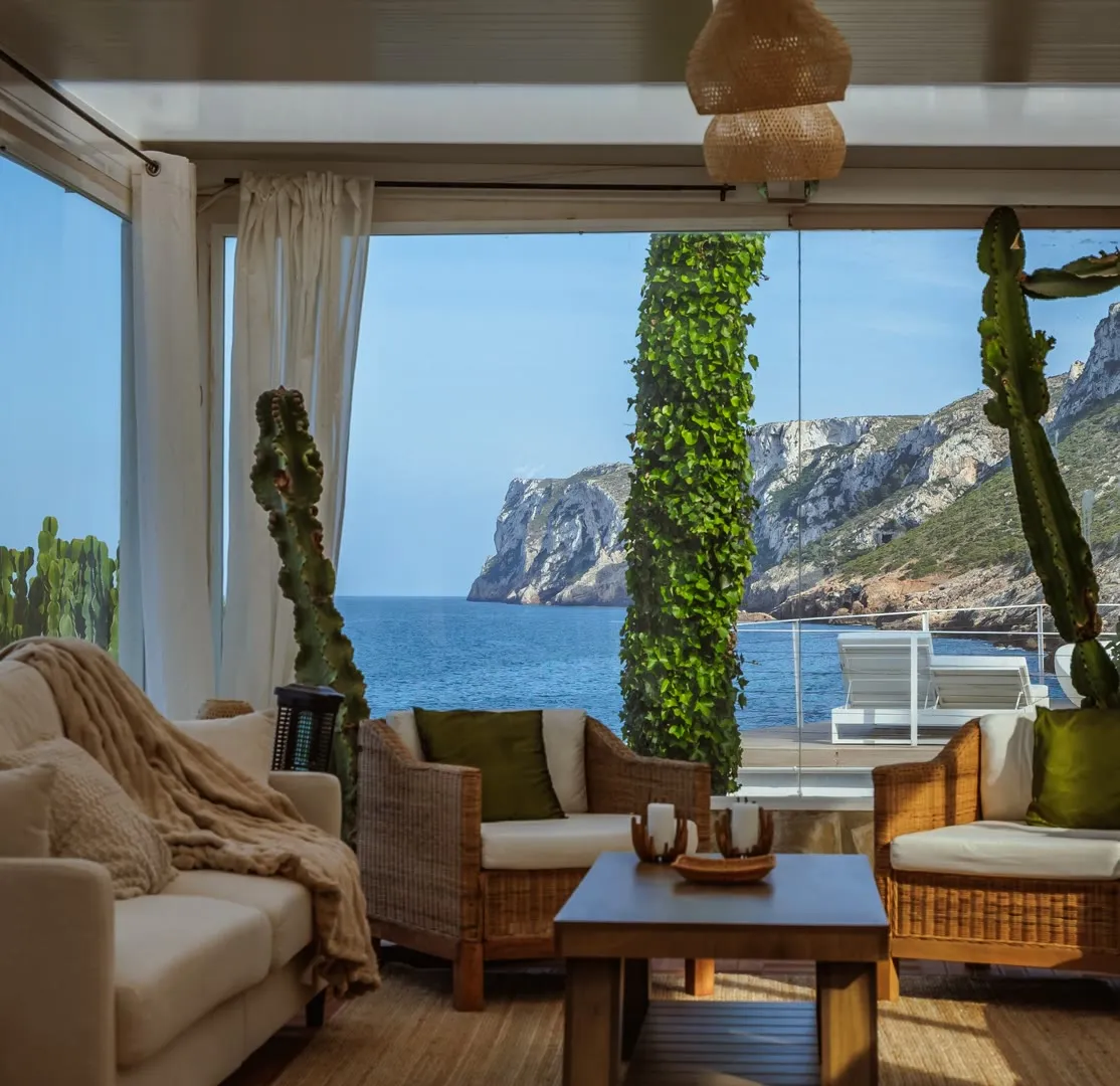Living room opening onto a sea-cliff view